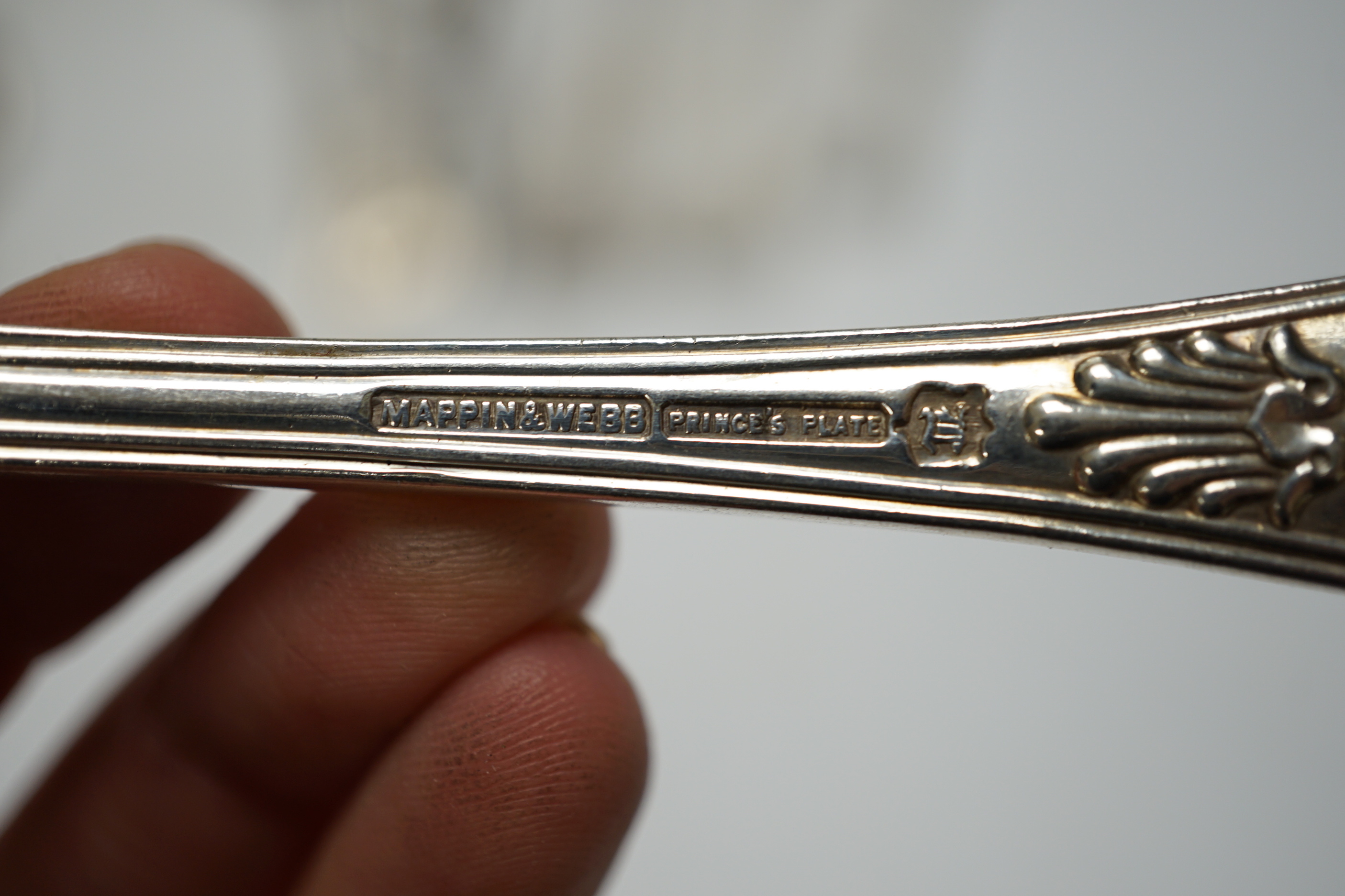 A silver plated part canteen of Kings pattern flatware, a pair of white metal tongs etc